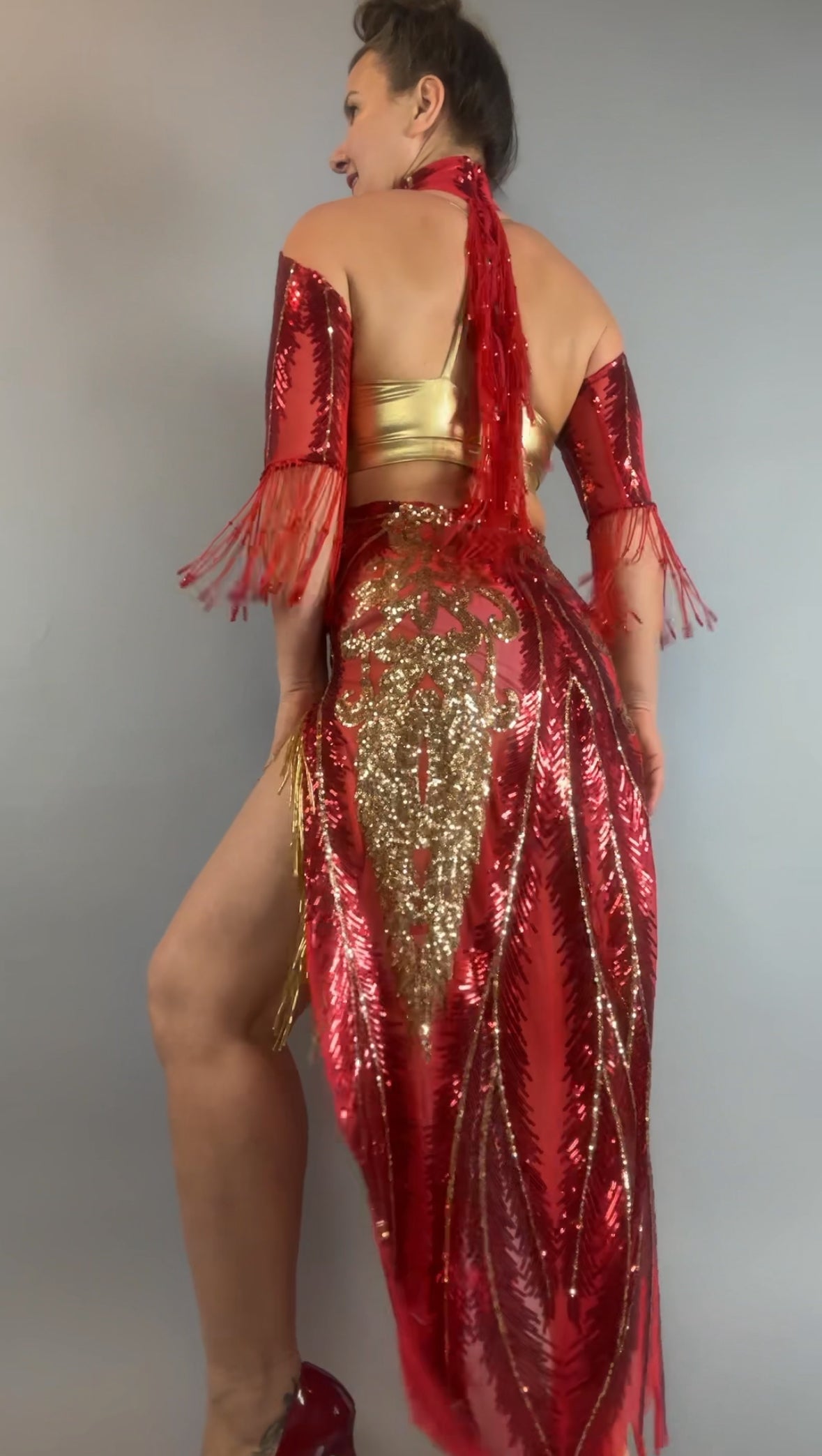 Person wearing the bearded French accessories Sequin Sheer Dress, a backless style with beaded fringe accessories for a bold, standout look.