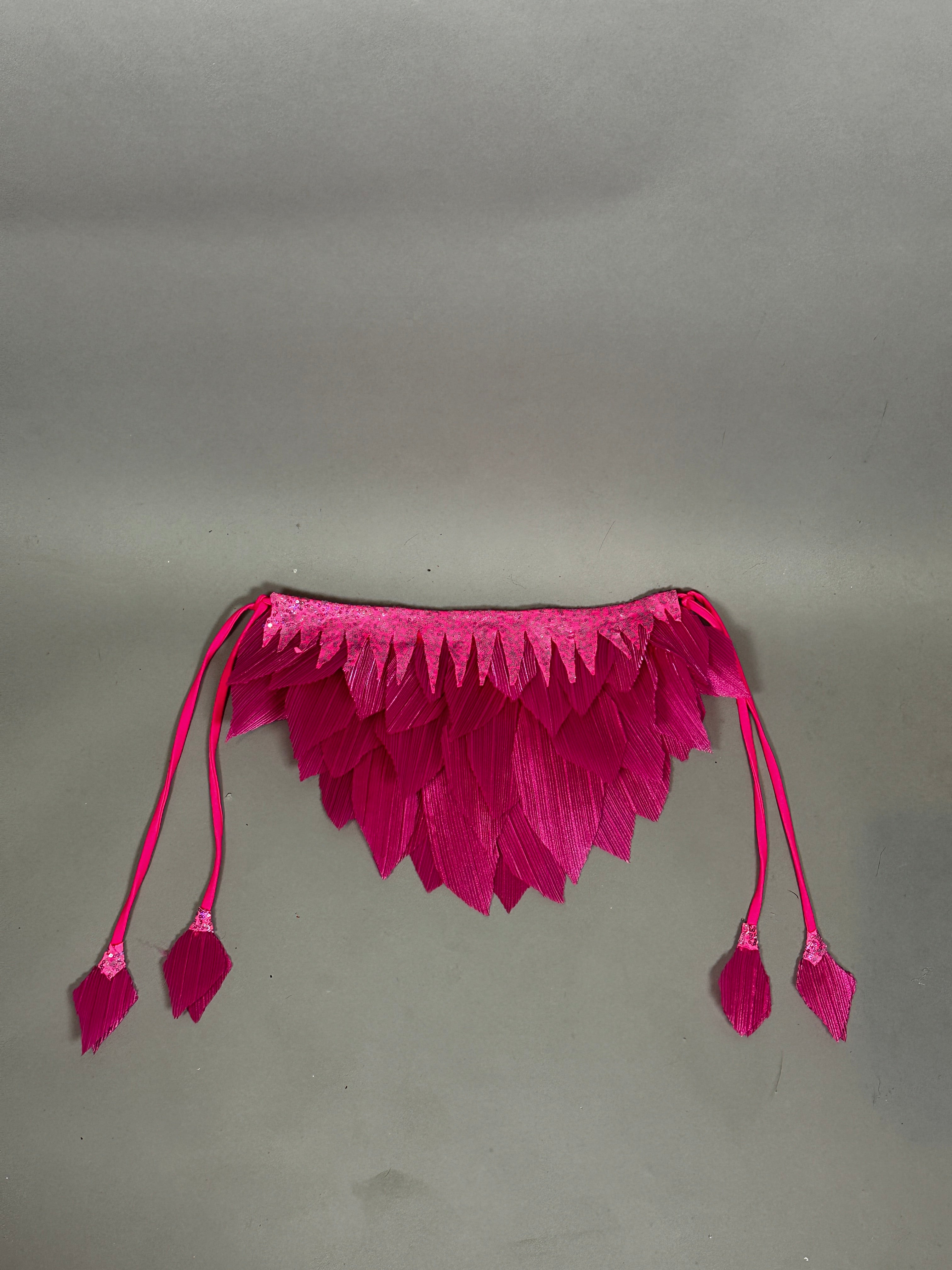 A pink bird full costume for aerial gymnastics, dancers, and TV productions is displayed on a plain gray background, featuring petal-like details and four tassels reminiscent of whimsical stage wear.