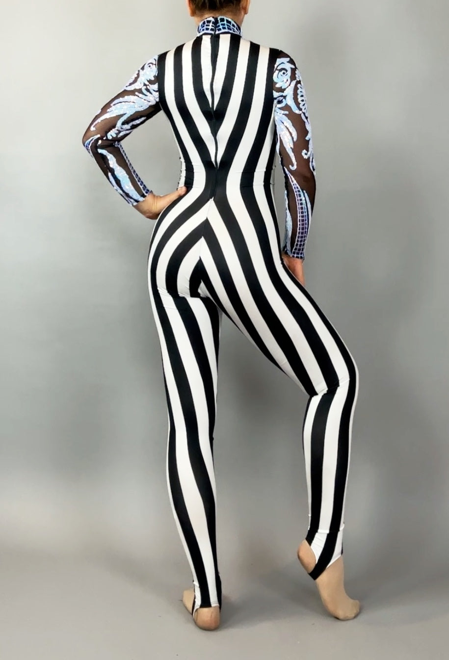 A person wears the Glamorous sequins Stripes Catsuit costume, featuring black and white vertical stripes, sheer patterned sleeves, and a sequined leaf design, shown from the back.