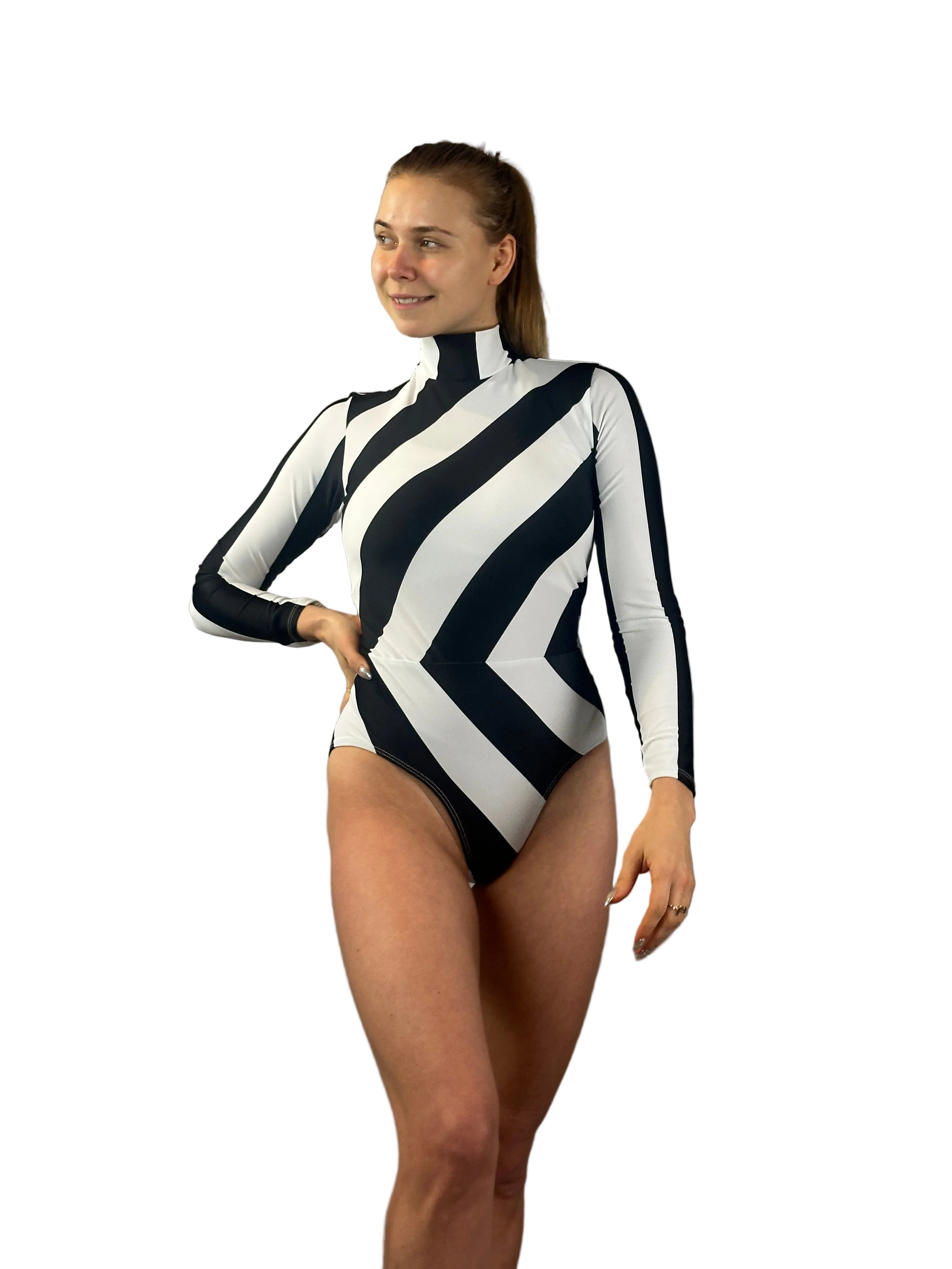 Smiling woman in a black and white striped leotard—mock neck, long sleeves, geometric print—perfect as a dance costume, aerialist outfit, or gymnastics wear, standing against a white background.