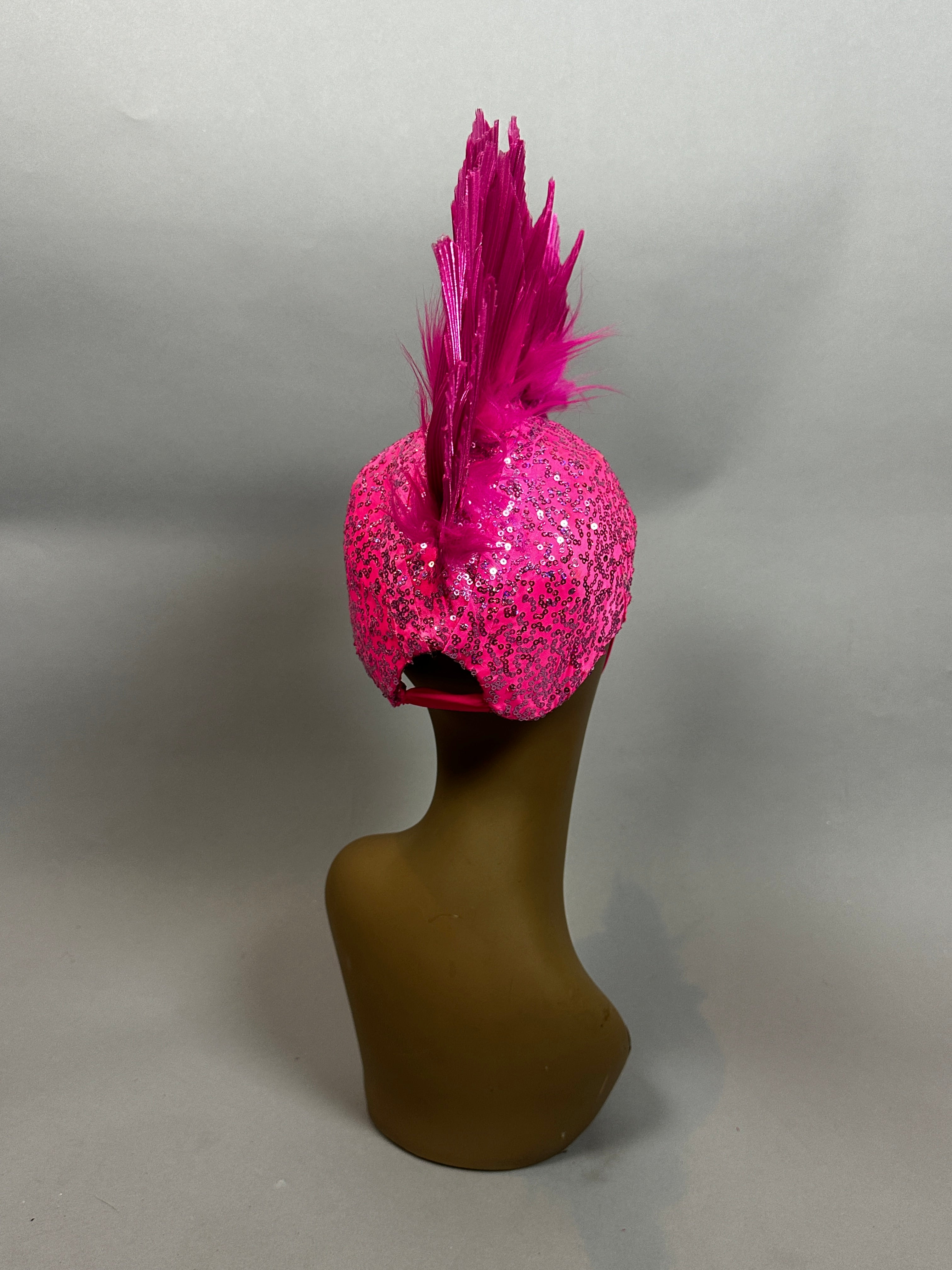 The Pink Bird Headpiece is a bold fairy hat accessory and aerialist headwear, perfect for theatrical costumes, festival outfits, and rave looks—shown atop a modern abstract brown mannequin head.