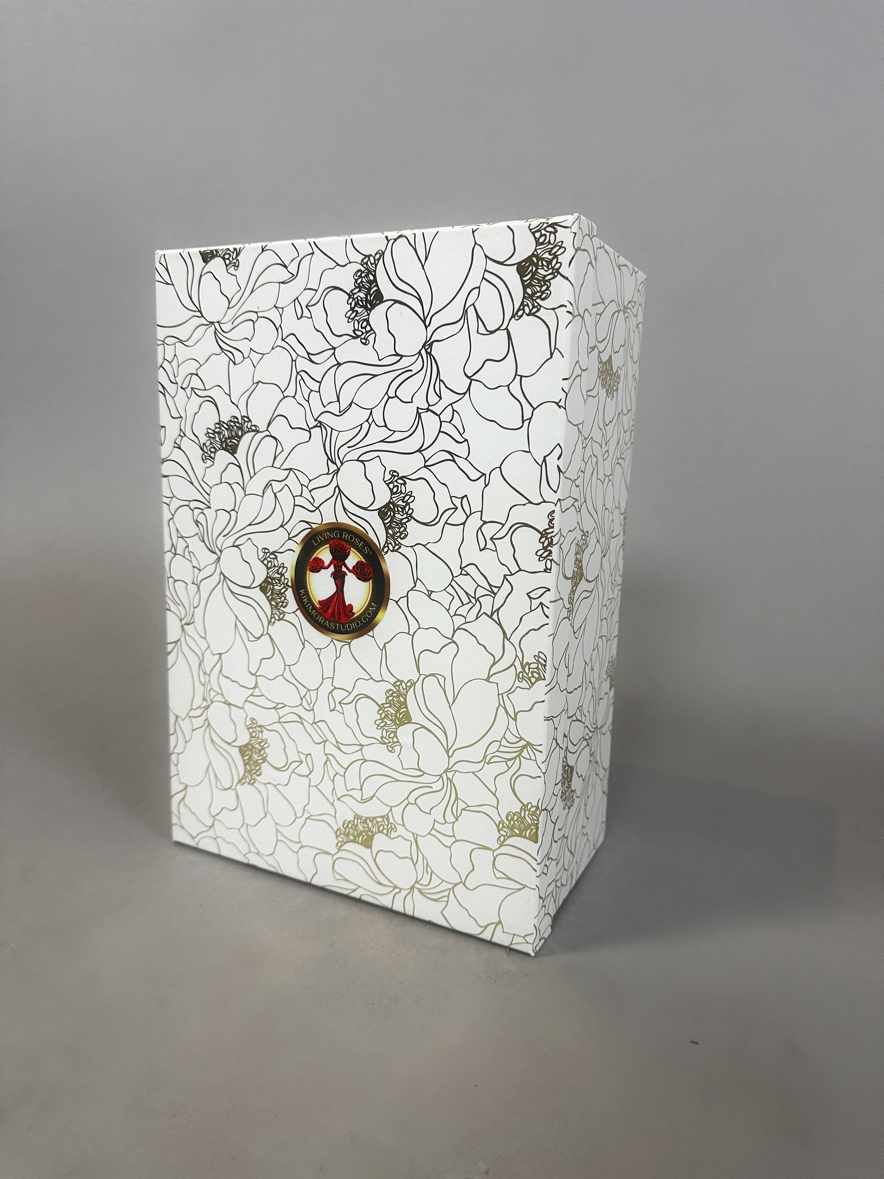 White box with black and gold floral pattern, featuring a small circular bird illustration on the front—packaging for the Mini Living Rose sculpture doll ornament from Kikimora Studio.