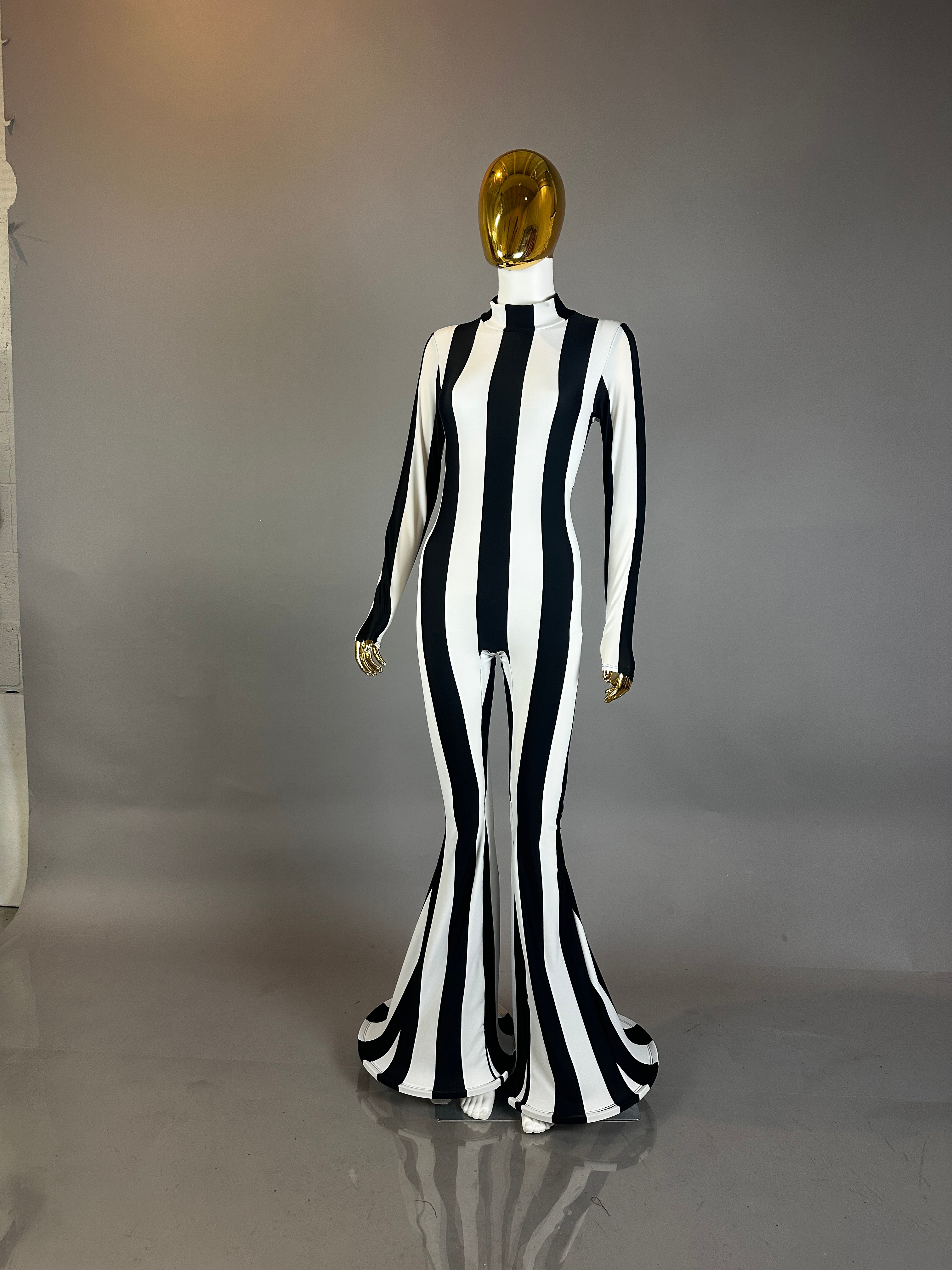 A mannequin models the Rave White Striped Catsuit with bellbottom legs—ideal as a performance costume—against a gray background.