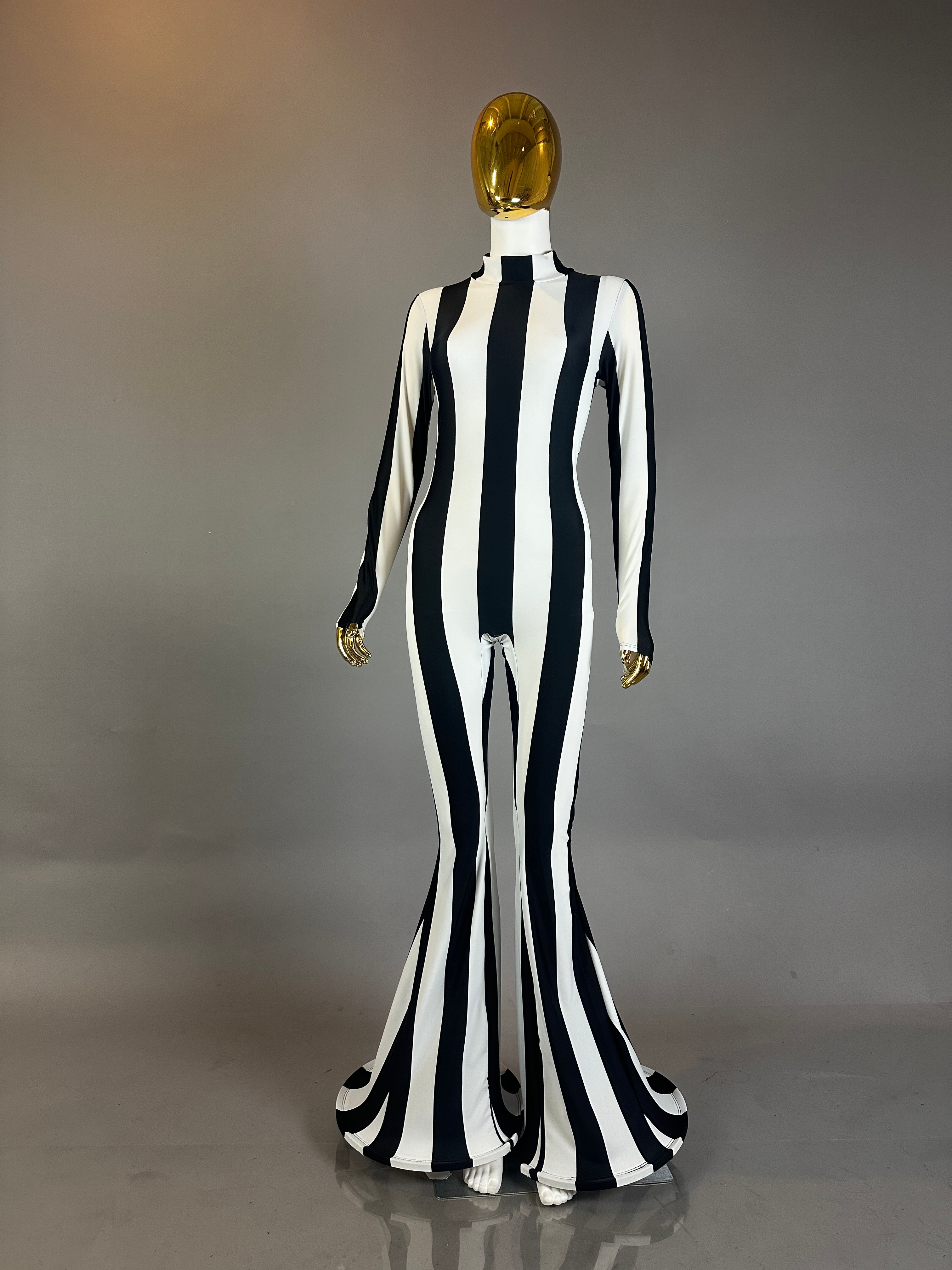 A mannequin showcases the Rave White Striped Catsuit with bellbottom legs, ideal for performance wear, set against a plain background.