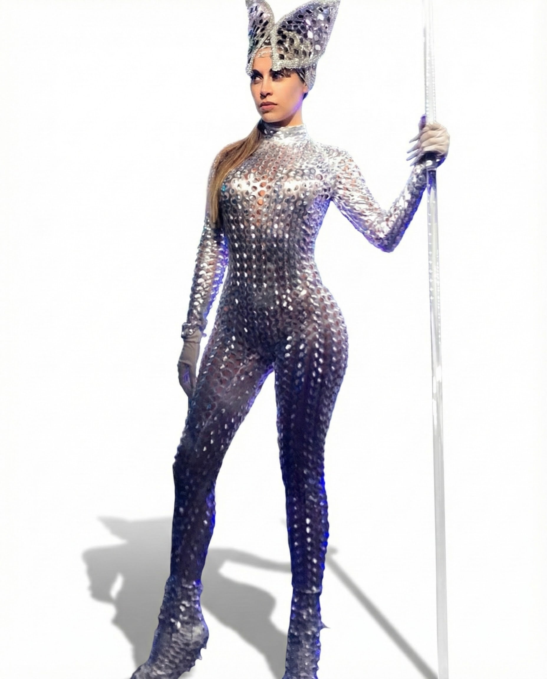 A person in the Futuristic Silver Robot Bodysuit—an exotic unisex costume for dance, alien cosplay & performance—wears a spiky 3D suit with a metallic finish and tall headpiece, holding a staff against a white background.
