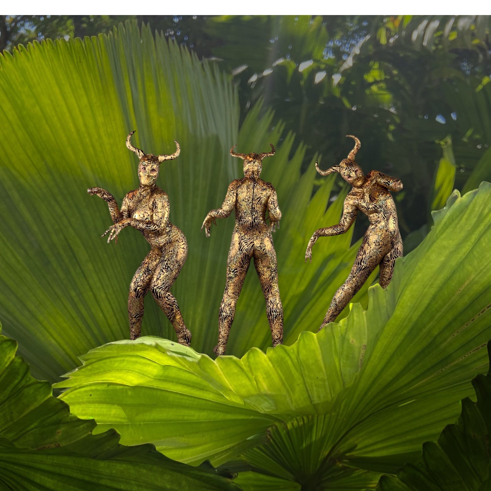 In a lush, natural setting, three figures in the Gold & Black Gazelle Creature Costume—complete with full sleeve catsuit, headdress, gloves, and socks—strike poses resembling majestic gazelles amid large green leaves.