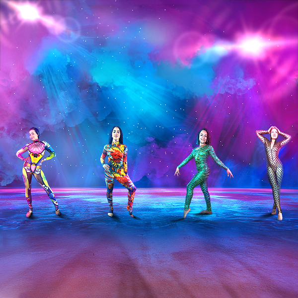 Four women in colorful bodysuits pose on a stage with vibrant purple, blue, and pink lighting.