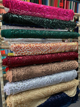 The Showgirl Costume is a stunning sequin bodysuit for men or women, ideal for crafting a dazzling dance costume with vibrant color patterns like pink, green, red, silver, and beige. Perfect for bellydance or bridal attire.