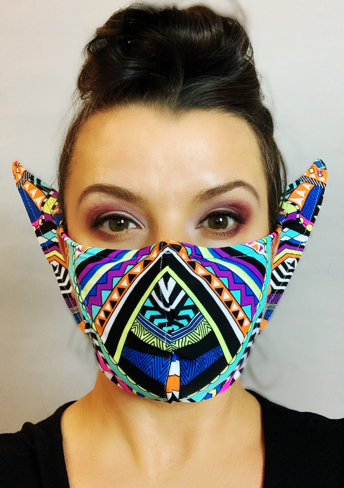 Person wearing a vibrant Glow Face Mask With 5 Layer HEPA Filterâa bold, eye-catching fashion accessory that combines style and protection.