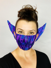 Woman smiles at the camera wearing the Elf Ears Face Mask for All Ages—a reusable Mandalorian Baby Yoda mask that&
