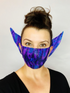 Woman smiles at the camera wearing the Elf Ears Face Mask for All Ages—a reusable Mandalorian Baby Yoda mask that&