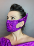 Person wearing the Elf Ears Face Mask for All Ages and matching Beautiful Futuristic Clothing, a reusable elf mask inspired by Mandalorian Baby Yoda, looking to the side in a shiny, textured purple lycra outfit.