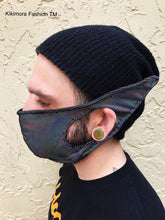 Person in a black beanie and Elf Ears Face Mask for All Ages—an iridescent, funny mask with fabric ear loops by Kikimora Fashion, inspired by Mandalorian Baby Yoda and made in the USA.
