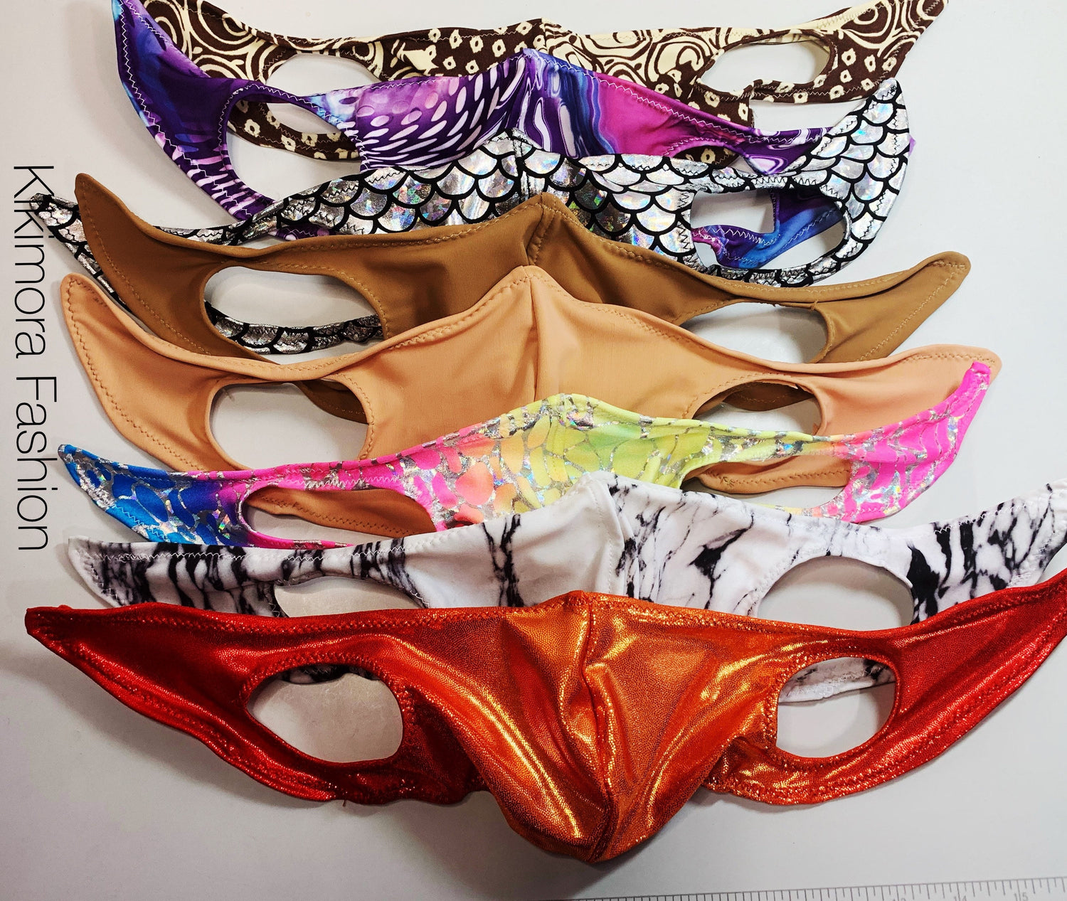Six vibrant, patterned Face Mask, Elf Ears Cosplay Costume Accessory, Breathing Face Masks made from soft Lycra are stacked together; "Kimora Fashion" text is visible on the left.