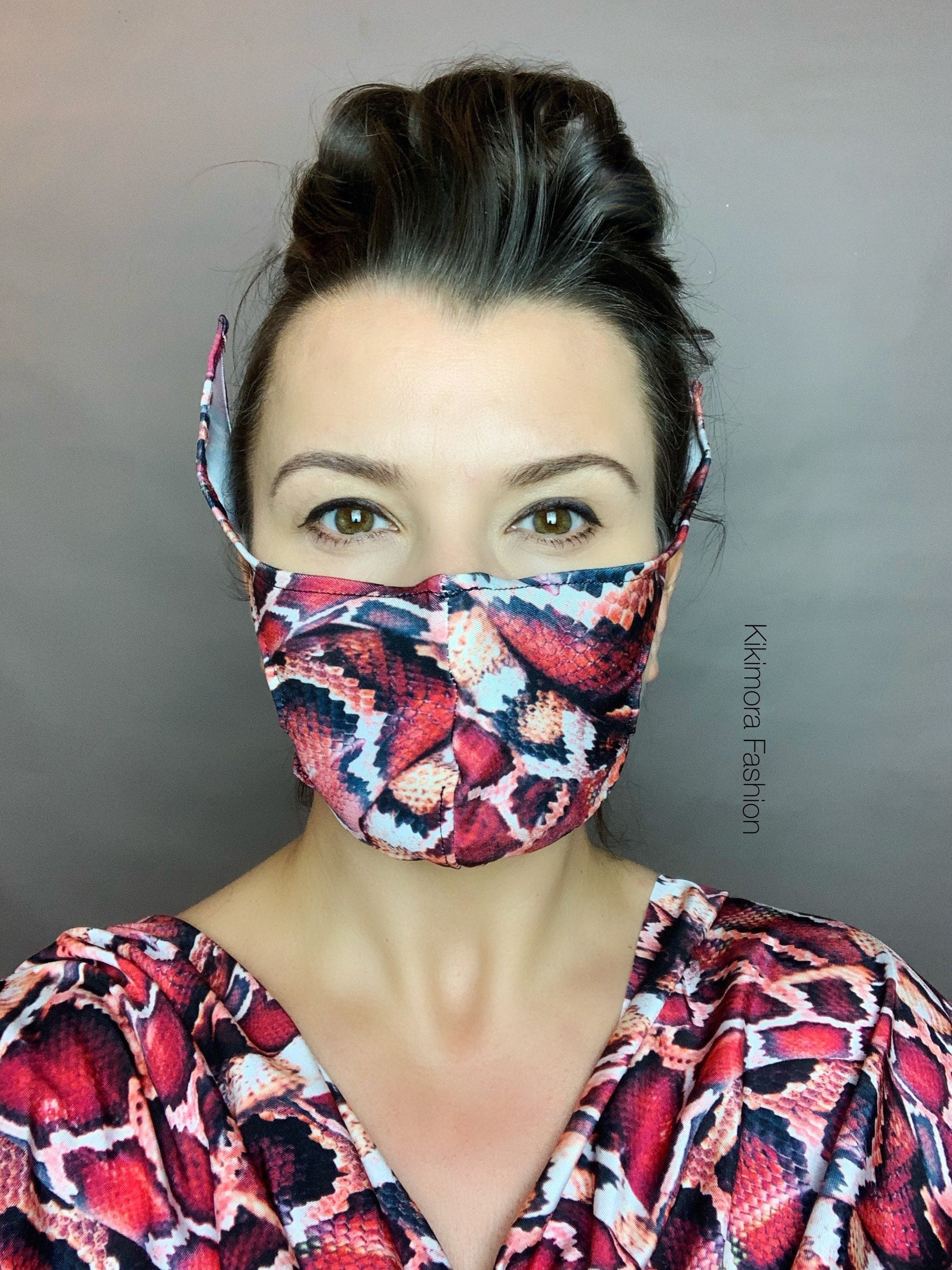 Woman wearing a Snake Print Elf Ears Face Mask, part of the Baby Yoda Mandalorian Costume—reusable, stylish, and sustainable with her hair tied back.