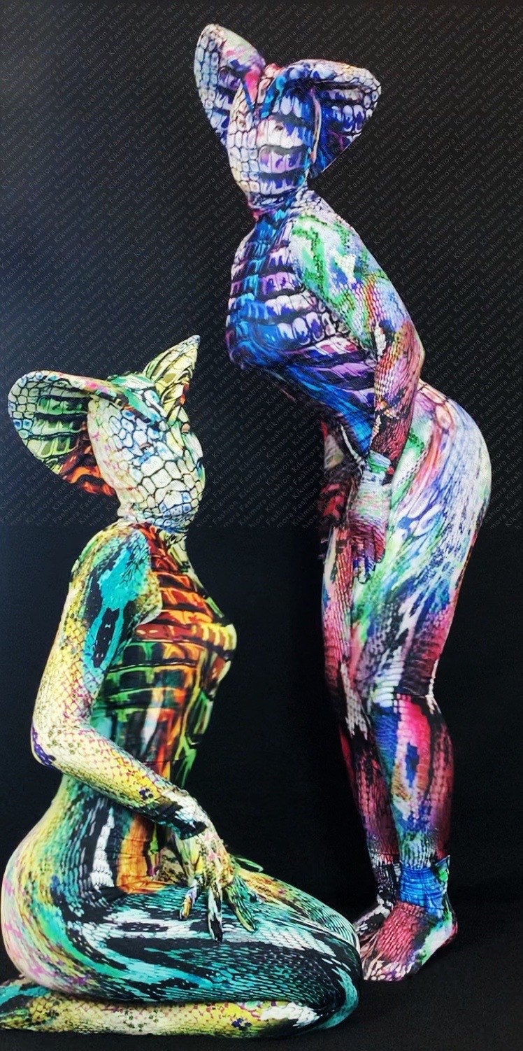 Two people pose in Fantasy Creature Snake Costumes—reptilian print zentai jumpsuits for women or men—showcasing vivid, exotic unitards ideal for fashion, dancewear, or contortionist performances.