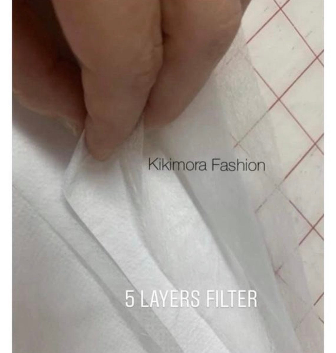 A hand separates layers of the Elf Ears Face Mask, highlighting its multi-layer filter and quality construction—showcasing Kikimora Fashion&