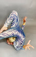 A contortionist captivates with a backbend against a gray background, wearing a Black and Red Floral Sequins Catsuit featuring a teardrop back opening and full sleeves.