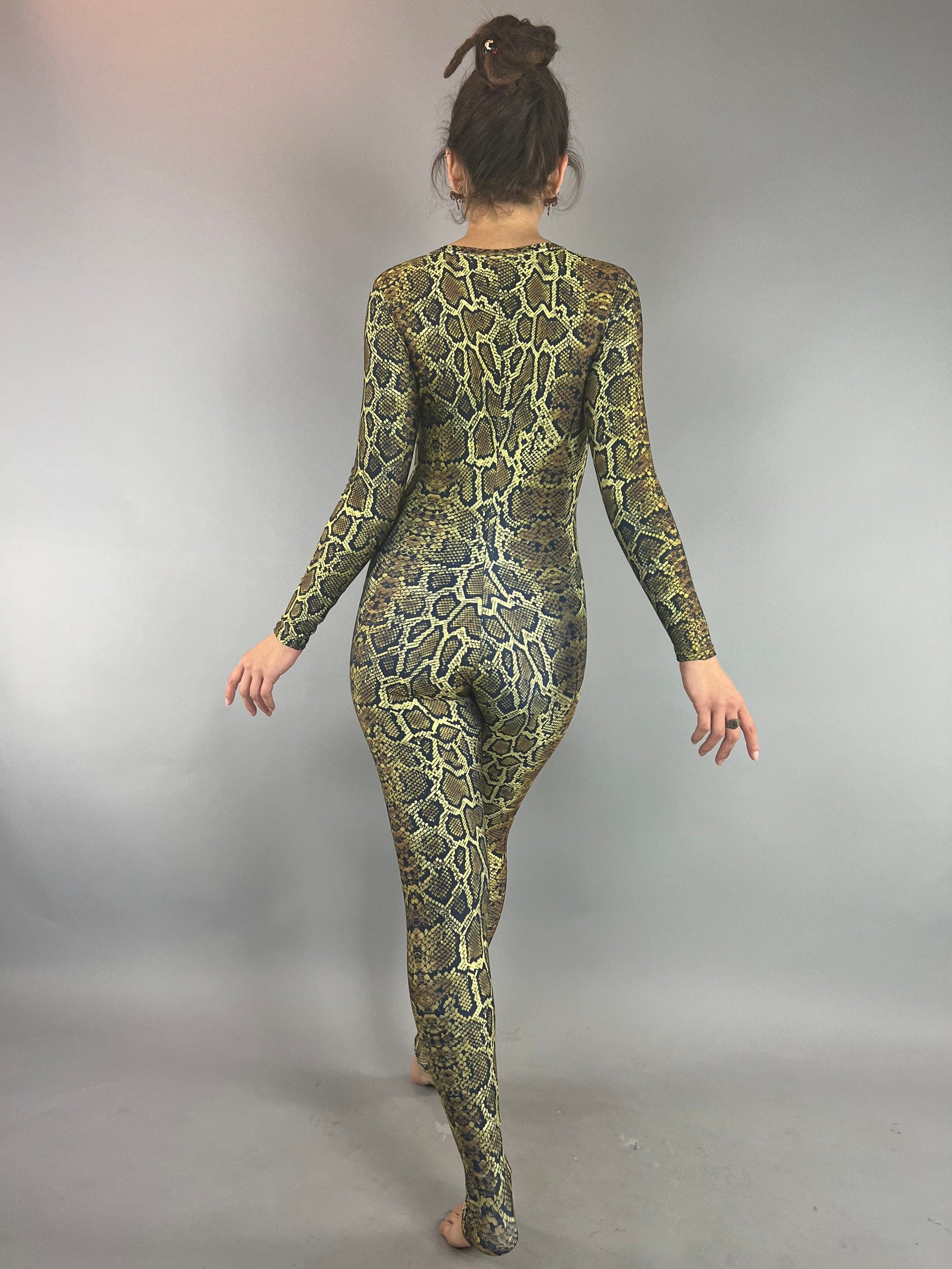 Model facing away in the Beautiful Snake Catsuit—an eye-catching yellow and black snakeskin-pattern bodysuit. Perfect for festival fashion, yoga, swimwear, and watersports; UV protective and trending now.