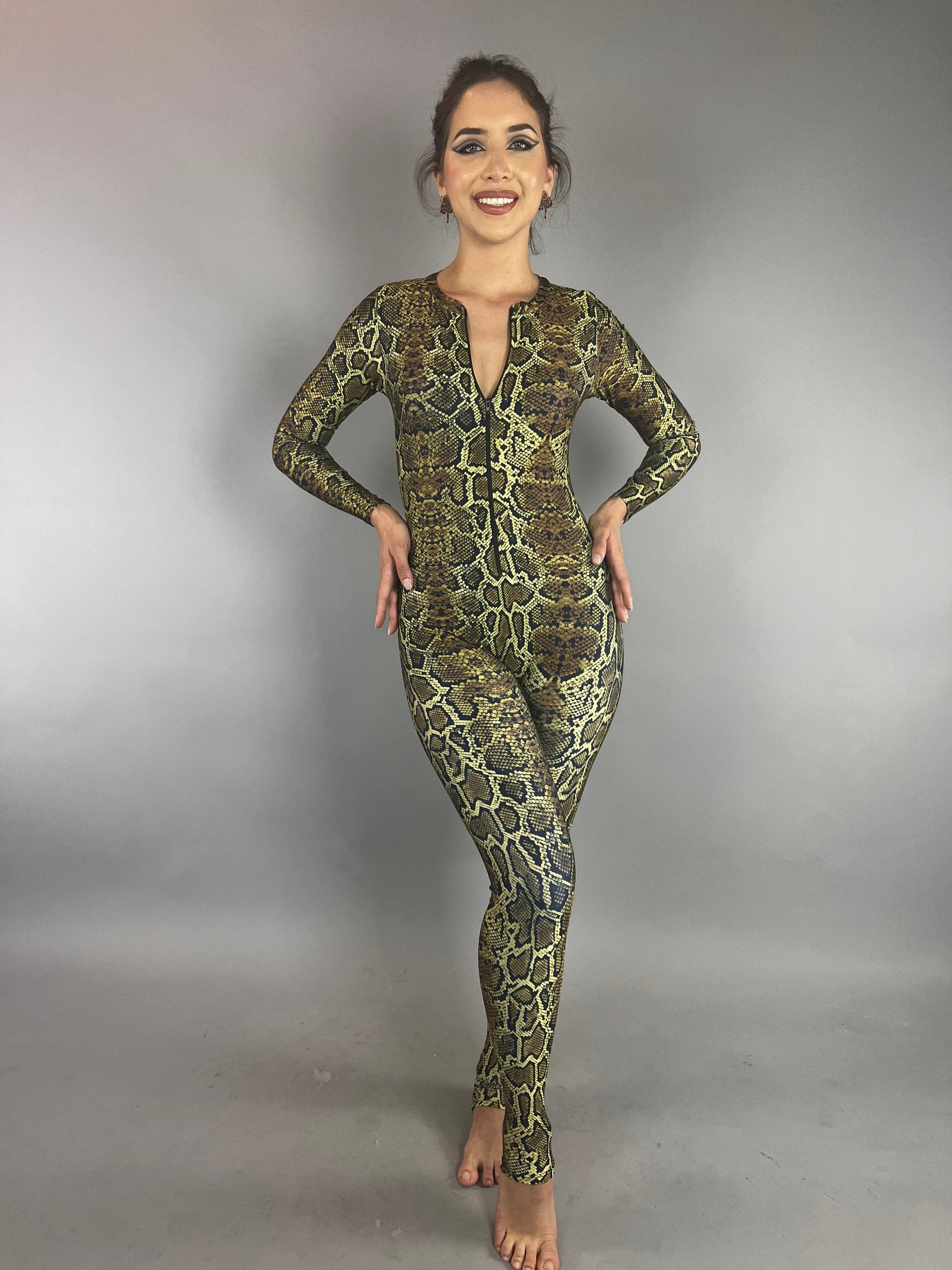 Woman models the Beautiful Snake Catsuit—an eye-catching, UV protective piece perfect for festivals, yoga, watersports, or swimsuits. Featuring a green and brown snakeskin print, it&