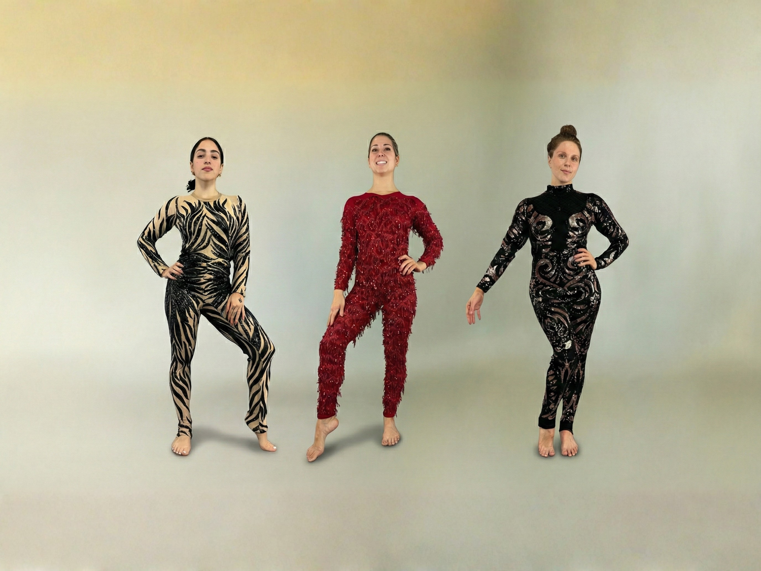 Three women in patterned jumpsuits pose confidently against a neutral background.