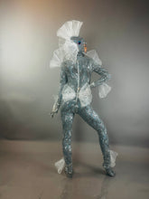 The Sea Creature is a silver, shiny, textured bodysuit with fins that creates a dazzling, futuristic aquatic look—a wearable sculpture and striking costume.