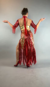 Model wearing the bearded French accessories Sequin Sheer Dress, featuring a backless design and beaded fringe accessories, poses with arms out and back to camera against a gray background.