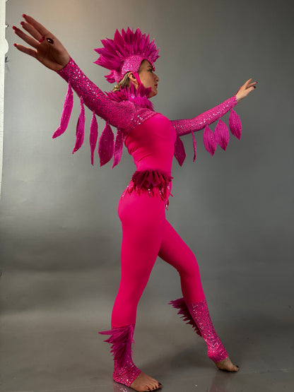 Model showcases the Pink bird full costume for aerial and dancers, featuring feathers, sparkles, and a bold headdress while posing with arms outstretched.