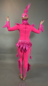 A person wears the Pink bird full costume for aerial gymnastics, dancers, and TV productions, standing barefoot with raised arms against a gray background.