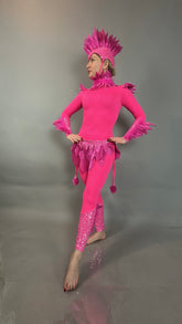 A person barefoot and facing left poses in the Pink Bird full costume for aerial gymnastics, dancers, and TV productions against a plain gray background.