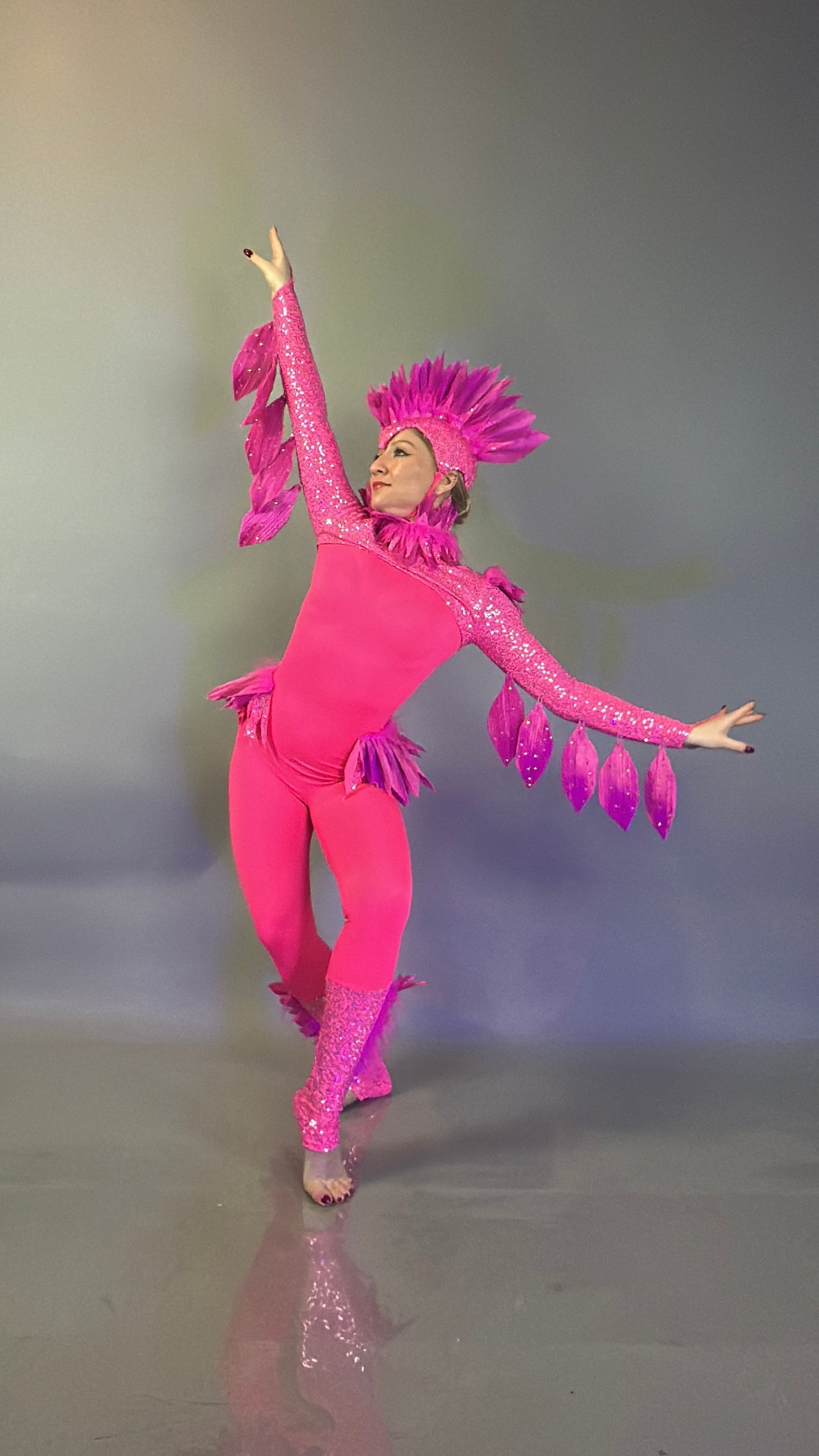 Person wearing the "Pink bird full costume for aerial and dancers" poses with arms raised and one leg bent on a plain background—ideal for theatrical performances.