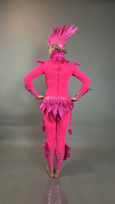 A person models the Pink bird full costume for aerial gymnastics, dancers, and TV productions—bright pink with feather details, worn barefoot, facing away.