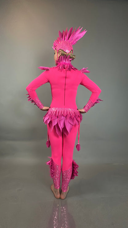 A person models the Pink bird full costume for aerial gymnastics, dancers, and TV productions—bright pink with feather details, worn barefoot, facing away.