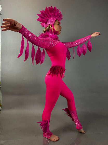 Person in a Pink bird full costume for aerial and dancers poses with arms outstretched against a plain gray background, highlighting the vibrant design of this theatrical show outfit.
