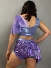 A person poses with their back to the camera wearing a Lavender Purple Sequin Dance Costume featuring high waist shorts with a half skirt, a crop top, and 4-way stretch mesh from the Fire Dancer Outfit.