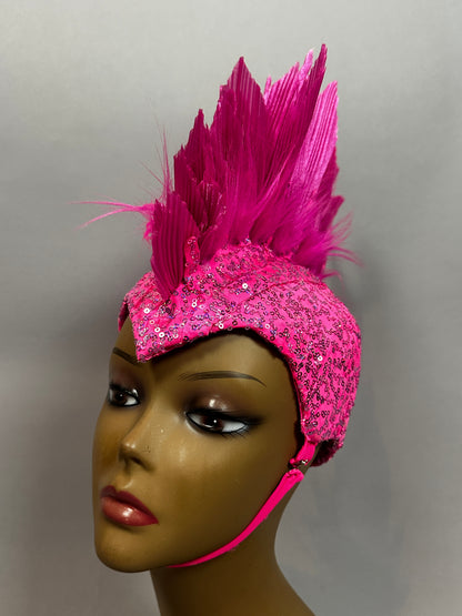 A mannequin models the Pink Bird Headpiece, a bright pink festival accessory with sequins, tall spiky feathers, and a chin strap—perfect for fairies, aerialists, theatrical costumes, or rave outfits.