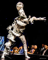 A performer walks the runway in a custom-fit Mushroom Creature Costume—an avant-garde, marble print spandex full-body suit designed as artistic fungus performance wear—while the seated audience looks on.