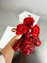 A hand holds the Mini Living Rose sculpture— a handcrafted, sequined doll ornament from Kikimora Studio—one of three magical art pieces, photographed with a white box and paper in the background.