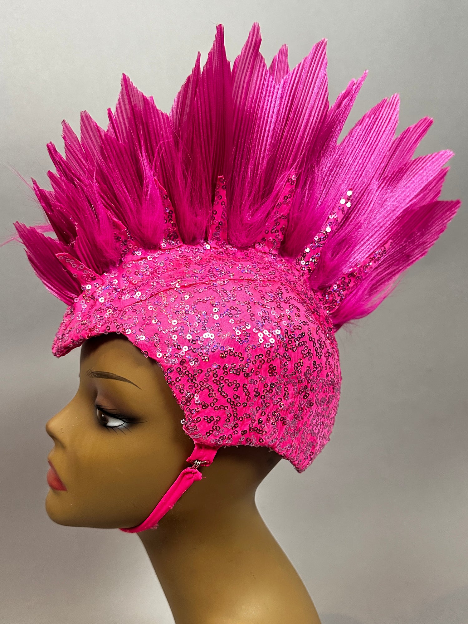 Mannequin head displays the Pink Bird Headpiece—an eye-catching sequin fairy hat accessory with tall, spiky feather-like accents—perfect for aerialists, festivals, theatrical costumes, and rave outfits.
