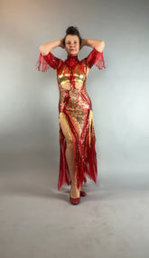 Woman poses confidently in the bearded French accessories Sequin Sheer Dress—backless and adorned with beaded fringe accessories—hands on head against a plain background.