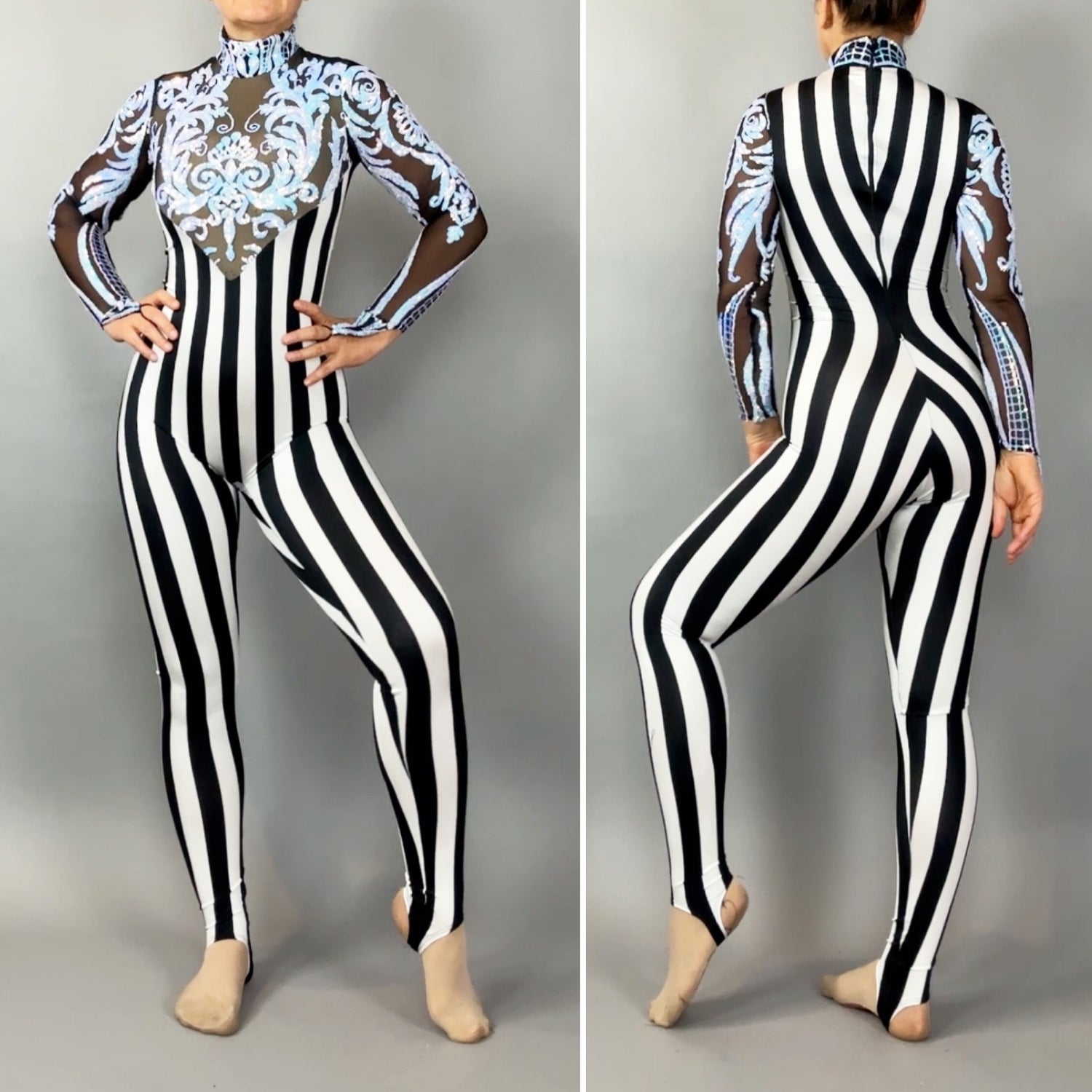 A person in the Glamorous sequins Stripes Catsuit costume, featuring black-and-white vertical stripes, sheer sleeves, blue ornamental chest detailing, and a sequined leaf design.
