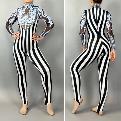 A person in the Glamorous sequins Stripes Catsuit costume, featuring black-and-white vertical stripes, sheer sleeves, blue ornamental chest detailing, and a sequined leaf design.