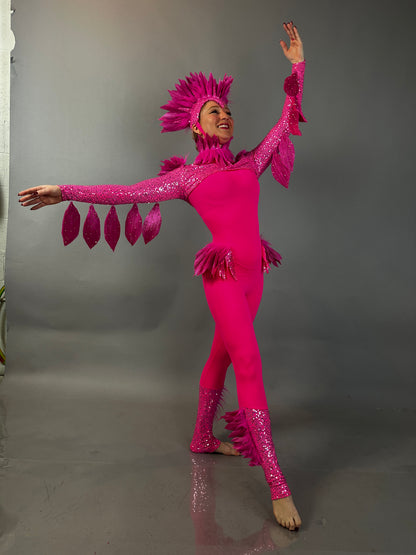 A person models the Pink bird full costume for aerial and dancers, striking a graceful pose against a plain gray background that highlights its stage-ready elegance.