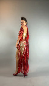 Woman wearing the bearded French accessories Sequin Sheer Dress with beaded fringe and backless design, featuring a thigh-high slit, posing sideways and smiling against a plain background.