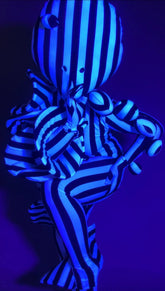 A person wearing a Black and White Striped Creature Costume with Sculptural Details featuring rounded, black-white shapes.