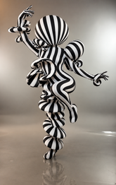 A person wearing the Creature Costume—a custom-fit, avant-garde full body suit made from marble print spandex—strikes a dramatic one-legged pose against a gray background, showcasing this UV glow performance wear and artistic fungus costume.