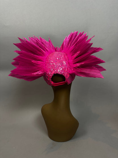 A mannequin showcases the Pink Bird Headpiece, a bright pink, spiked, and glittery sequin fairy hat for aerialists and theatrical wear, against a plain background.