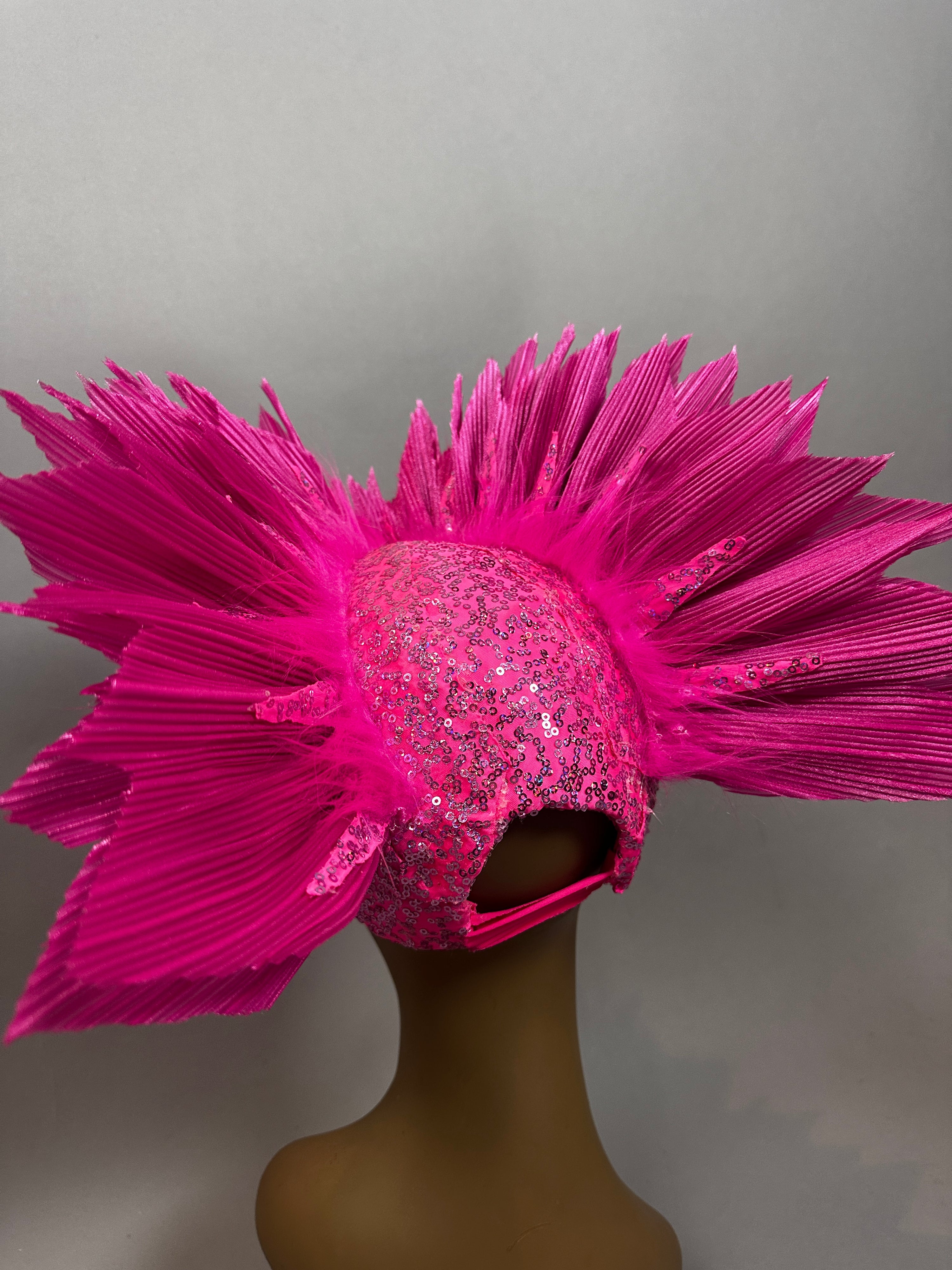 A mannequin displays the Pink Bird Headpiece, a bright pink fairy hat with large spiked pleated fans, perfect for aerialists and theatrical performances.