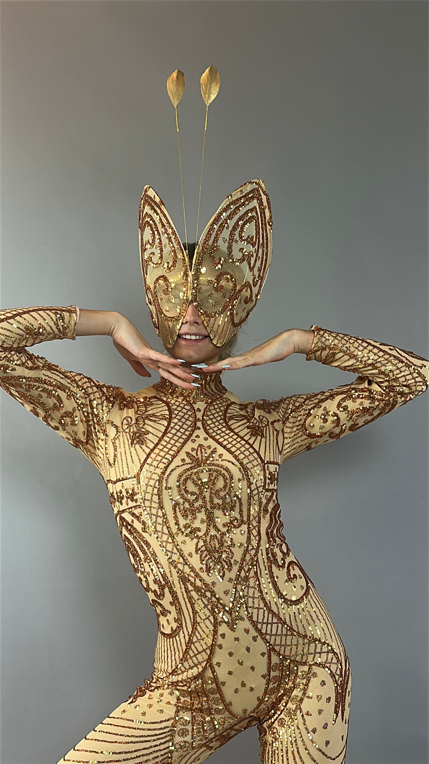 Person wearing the Black Sequin Butterfly Headpiece—a sheer mesh fairy hat with feather antennae fascinator—posing festively with hands under chin, perfect as a theatrical holiday costume accessory.