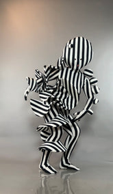 Black and White Striped Creature Costume with sculptural, ruffled, and spherical parts in a black-and-white jumpsuit.